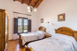 a bedroom with two beds and a window at Finca Liarte in Murcia +89 photos