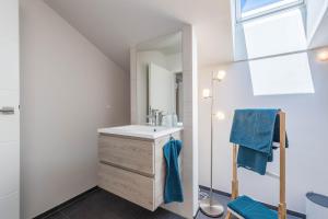 a bathroom with a sink and a mirror at Ferienwohnung Rudi in Taching am See