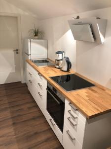 a kitchen with a sink and a stove at Ferienwohnung Rudi in Taching am See