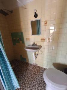 a bathroom with a sink and a toilet at Hotel Casa Lucina in Zihuatanejo +42 photos