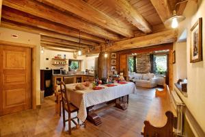 a kitchen and dining room with a table in a room at Chalet 1175 - Grand-haury in Arvier