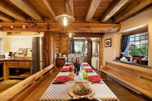 a kitchen with a long table with red plates at Chalet 1175 - Grand-haury in Arvier +18 photos