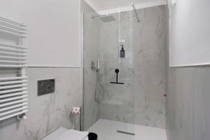 a bathroom with a shower with a glass door at Cinema Boutique Apartment Sestri in Sestri Levante +22 photos