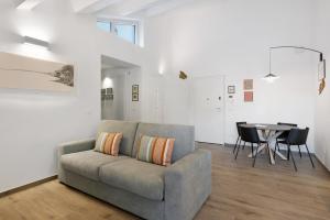 a living room with a couch and a table at Cinema Boutique Apartment Sestri in Sestri Levante