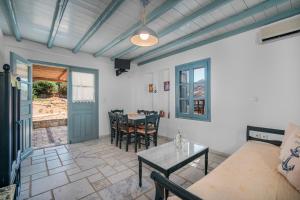 a living room with a table and a couch at Ammos 1 in Serifos Chora +28 photos