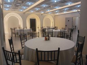 a banquet hall with white tables and chairs at Hotel Tiski Cvet in Novi Bečej +23 photos