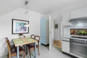 a kitchen and dining room with a table and chairs at Schöne Dachgeschoss Wohnung in Warstein