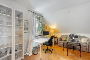 a living room with a desk and a chair at Schöne Dachgeschoss Wohnung in Warstein