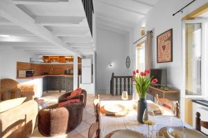 a living room with a table and some chairs at Maison Séjour Capraisien in Saint-Capraise-de-Lalinde