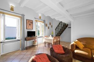 a living room with a couch and a table at Maison Séjour Capraisien in Saint-Capraise-de-Lalinde