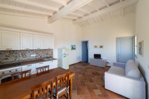 a kitchen and living room with a table and a couch at L' Elicriso in Marciana