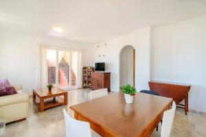 a living room with a table and a couch at El Mirador in Mutxamel