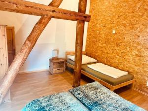 a bedroom with two bunk beds and a wooden floor at Alter Stall in Melzow