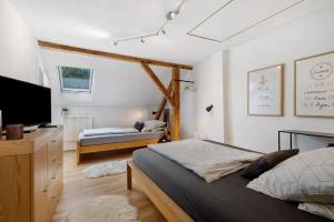 a bedroom with two beds and a flat screen tv at Ferienhaus Alte Wognerei in Fuchsmühl