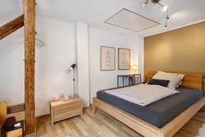 a bedroom with a bed and a night stand with candles at Ferienhaus Alte Wognerei in Fuchsmühl