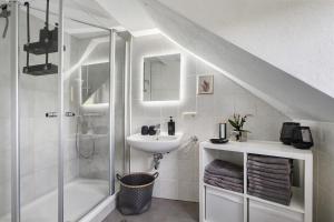 a white bathroom with a sink and a shower at Ferienhaus Alte Wognerei in Fuchsmühl +28 photos
