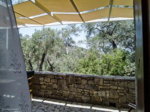 a view of a stone wall and trees at Adamantia Studio S2 in Gaios