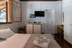 a bedroom with a bed with two towels on it at Krinos apartment 1 in Kharadhiátika