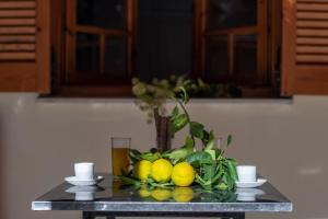 a table with a bunch of lemons on it at Krinos apartment 1 in Kharadhiátika +14 photos