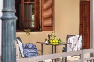 a table with a bowl of fruit on it on a porch at Krinos apartment 1 in Kharadhiátika