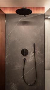 a shower with a shower head and a hose at Ufogel in Nußdorf +37 photos