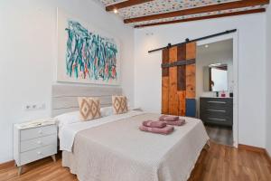 a bedroom with a bed with two pink towels on it at Dulce in Benissa +19 photos