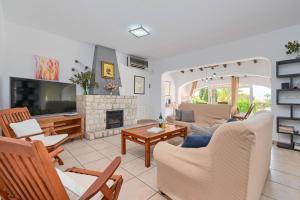 a living room filled with furniture and a fireplace at Dulce in Benissa