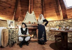 a man and a woman in a room with a fireplace at Pinnetta Sarda in Codrongianos +32 photos