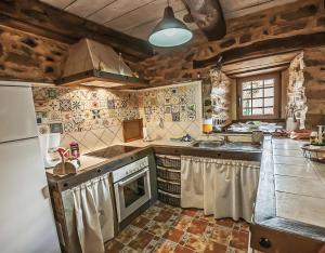 a kitchen with a sink and a stove top oven at Jumaca in Valdespino de Somoza +12 photos