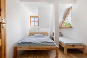 a small bedroom with a bed and a window at Ferienwohnung Weiden in Weiden