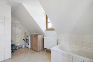 a bathroom with a toilet and a bath tub at Ferienwohnung Weiden in Weiden +13 photos