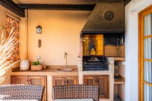 a kitchen with a stove and a counter top at Montemar 33 in Port de Soller