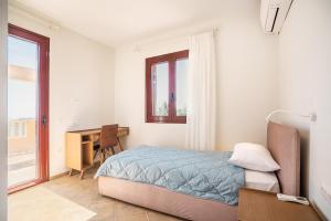 a bedroom with a bed and a desk and a window at Sky Hills in Rhodes Town +33 photos