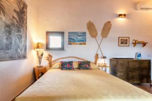 a bedroom with a bed with two pillows on it at Stazzo Jana in Trinità d'Agultu e Vignola