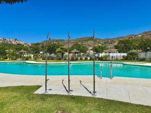 a swimming pool with poles in the middle of it at Beach Apartment with Pool, Terrace in Taramay