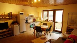 a kitchen with a table and a kitchen with a refrigerator at Casa Mia 2 in Bad Dürkheim