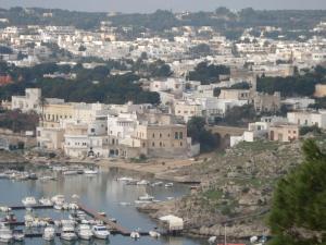a view of a city with boats in a harbor at Lu Rusciu De Lu Vientu in Castrignano del Capo