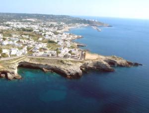 an aerial view of an island in the ocean at Lu Rusciu De Lu Vientu in Castrignano del Capo
