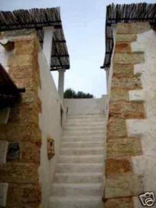 a set of stairs leading up to a building at Lu Rusciu De Lu Vientu in Castrignano del Capo +2 photos