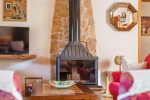 a living room with a wood stove in a room at Son Barbudet in Campos