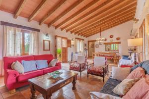 a living room with red couches and a table at Son Barbudet in Campos