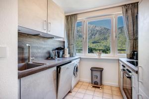 a kitchen with a sink and a dishwasher at The View in Bad Reichenhall