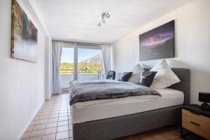 a bedroom with a bed and a window with a view at The View in Bad Reichenhall