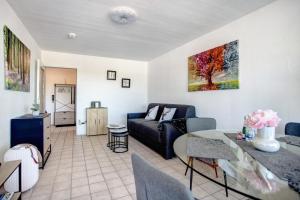 a living room with a couch and a table at The View in Bad Reichenhall +13 photos