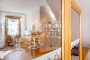 a group of wine glasses sitting on a counter at Appartamento nel borgo di Chatillon in Châtillon +23 photos