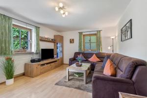 a living room with a couch and a tv at Ferienwohnung Edelweiß in Bad Reichenhall