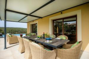 a dining room with a table and chairs at Luxurious villa Sol de Mallorca in Sol de Mallorca