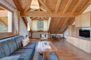 a living room with a blue couch and a table at Hofanger in Lagundo