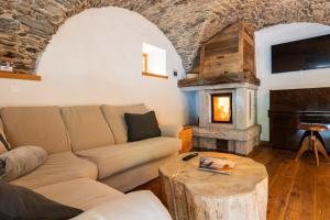 a living room with a couch and a fireplace at Maroc Mountain Chalet in Madonna di Campiglio