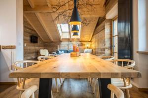 a dining room with a large wooden table and chairs at Valentin36 Apartment Ritten in Funes +32 photos